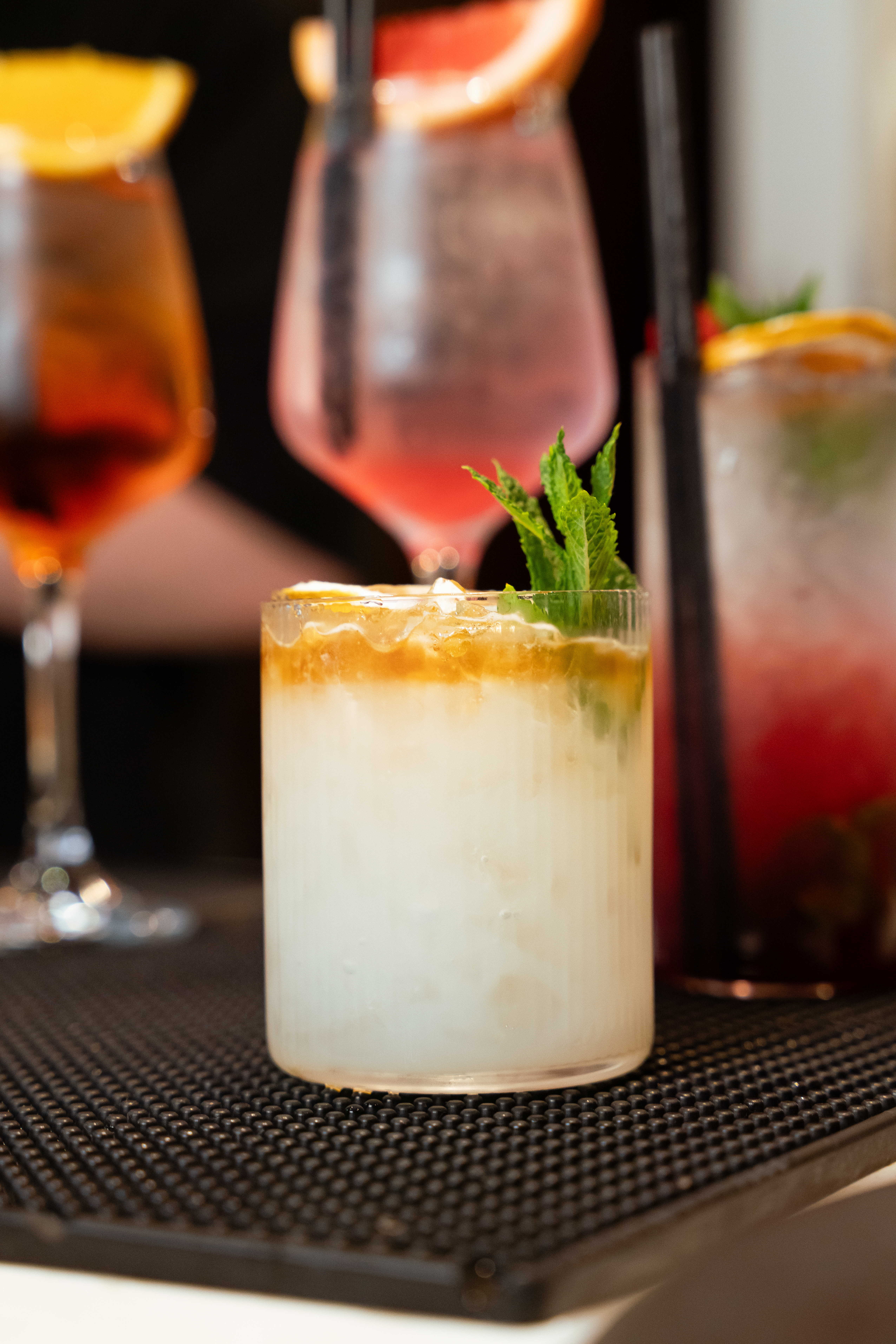 Creamy cocktail with citrus and mint at Mate's